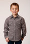 Young boy wearing a patterned shirt against a plain background