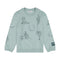 Light blue sweatshirt with black graphics and Wrangler logo near cuff