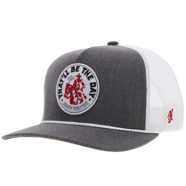 A gray and white 5-panel snapback hat with a red and white circular patch on the front and the Hooey logo in red on the brim.