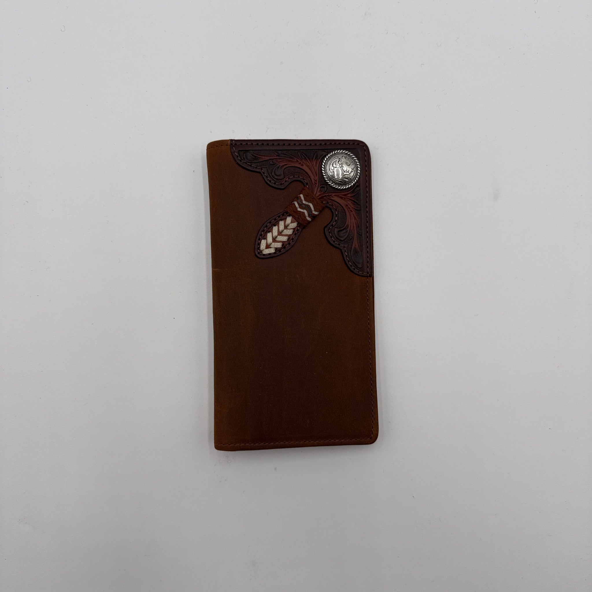 Brown leather wallet with decorative elements on a white background