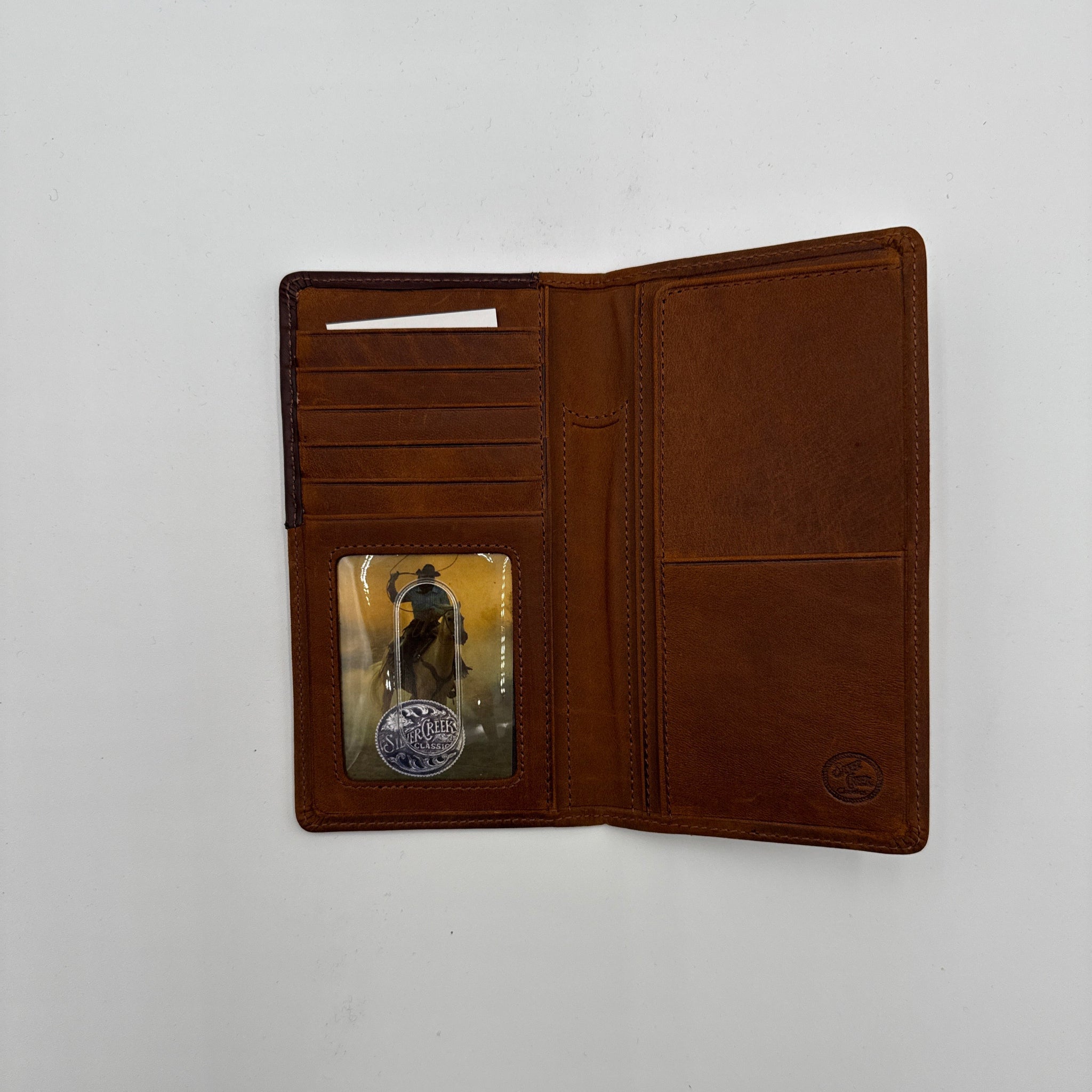 Brown leather wallet with a card on a white background