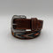 Brown leather belt with decorative buckle on a light gray background