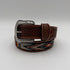 Brown leather belt with decorative buckle on a light gray background