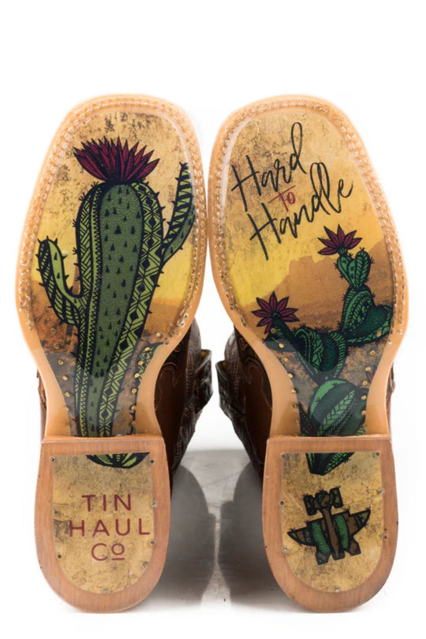Boot soles with cactus design and 'Tin Haul Co.' branding on a white background
