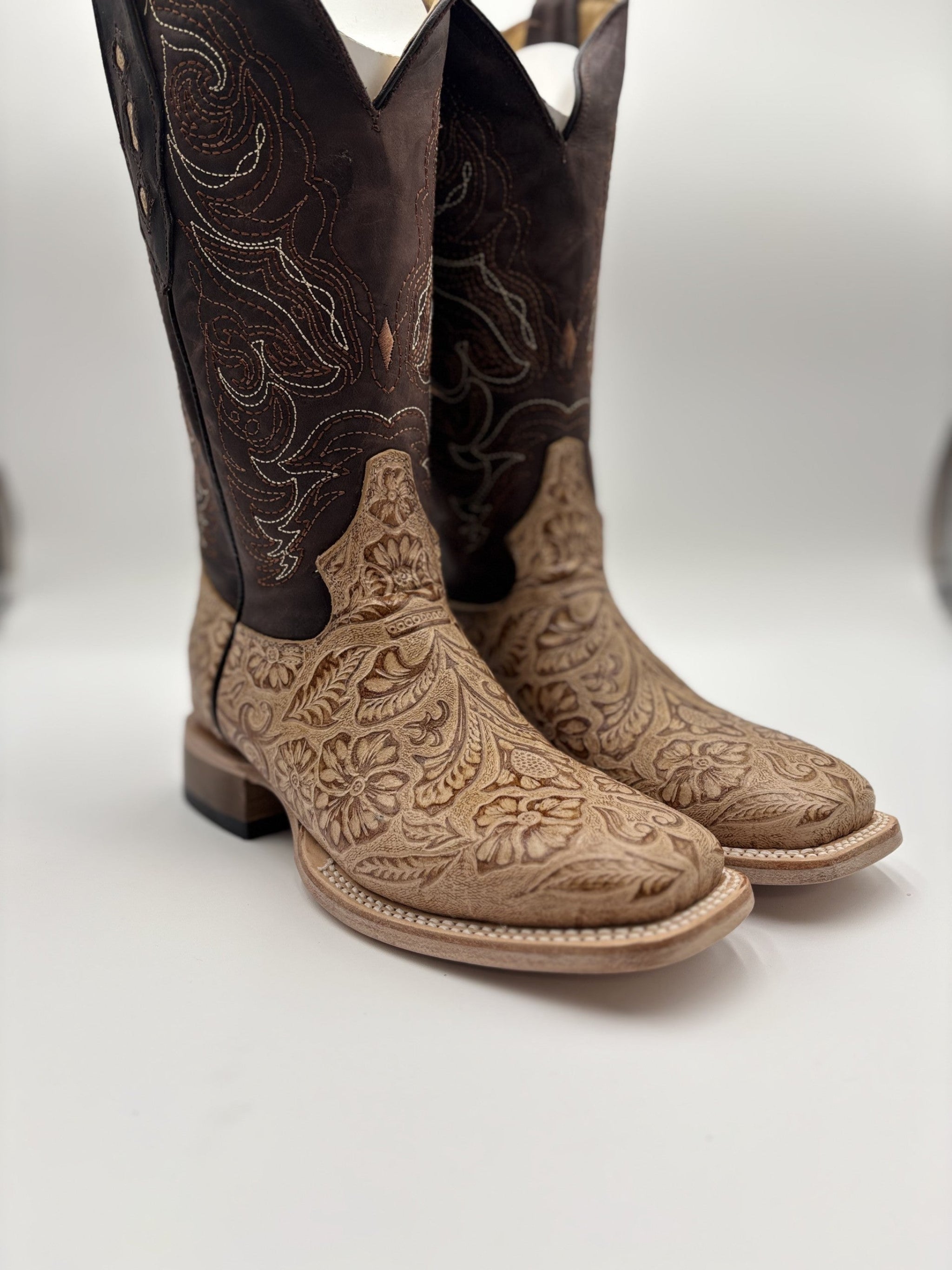Pair of cowboy boots with intricate designs on a white background