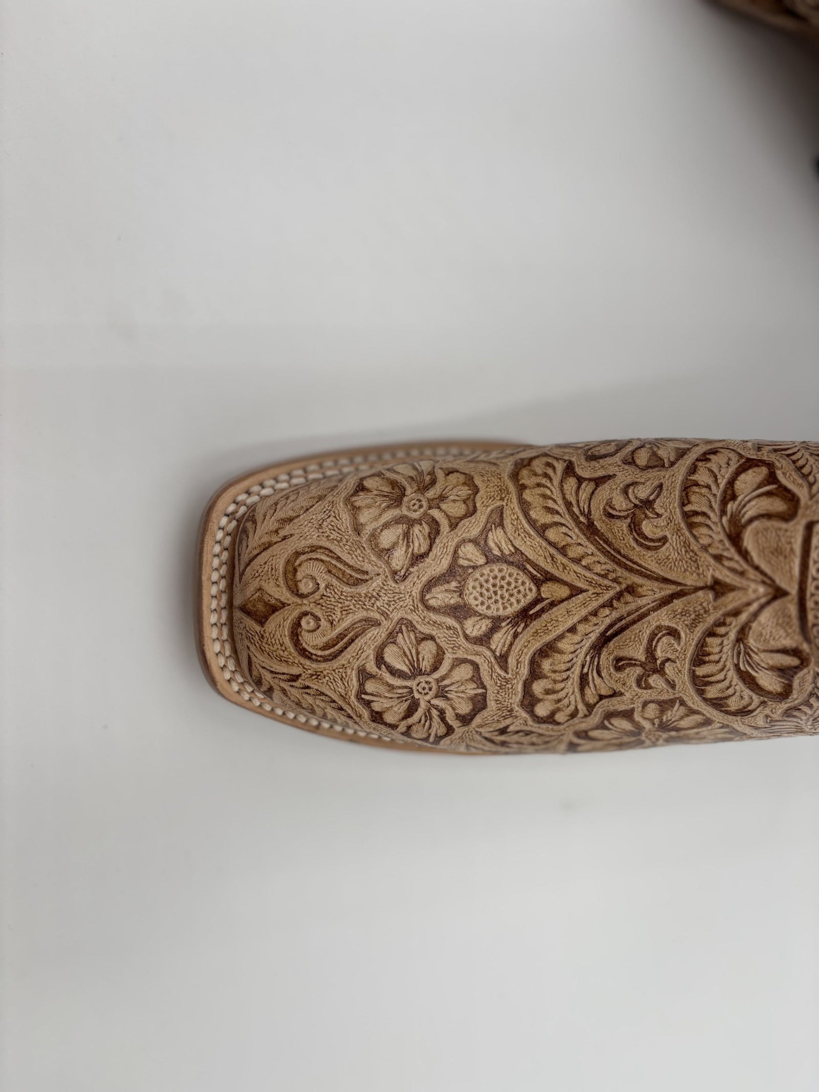 Decorative leather embossing tool on a white background