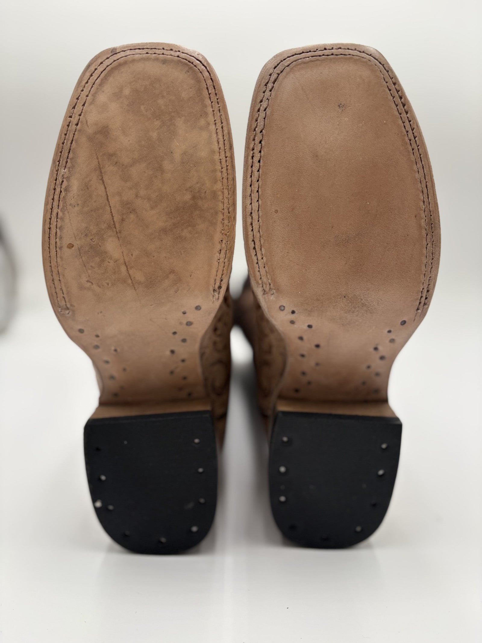 Brown leather boot soles on a white background