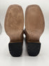 Brown leather boot soles on a white background