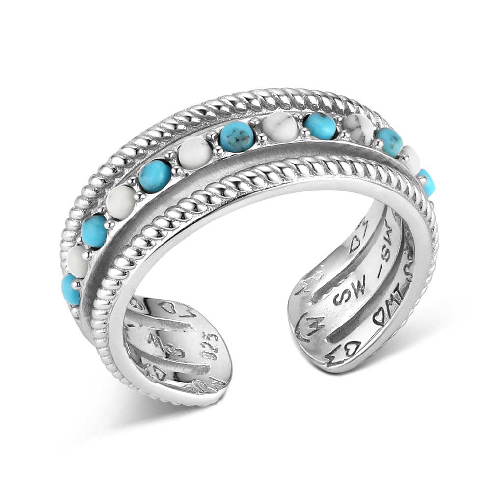 Silver ring with turquoise and white stones on a white background