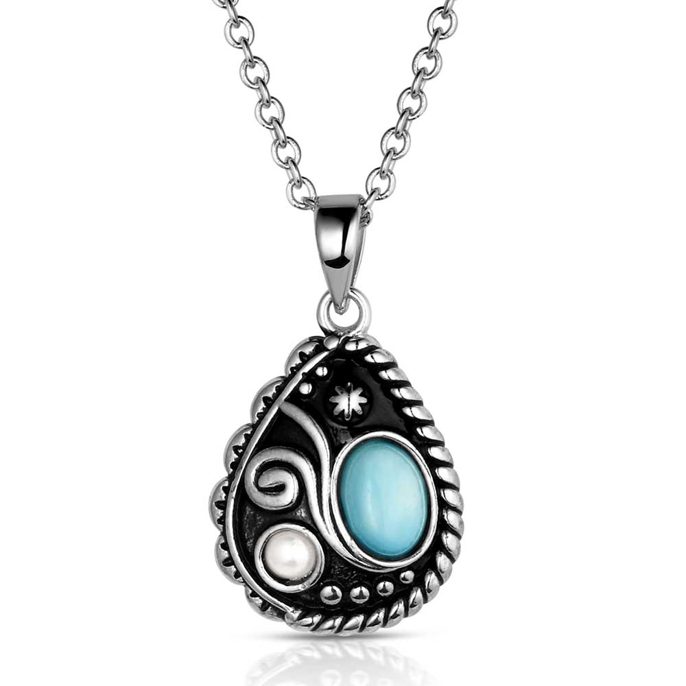 Silver necklace with a decorative pendant featuring a blue gemstone 