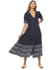 navy blue dress with white dots and a patterned hemline and button down the front.
