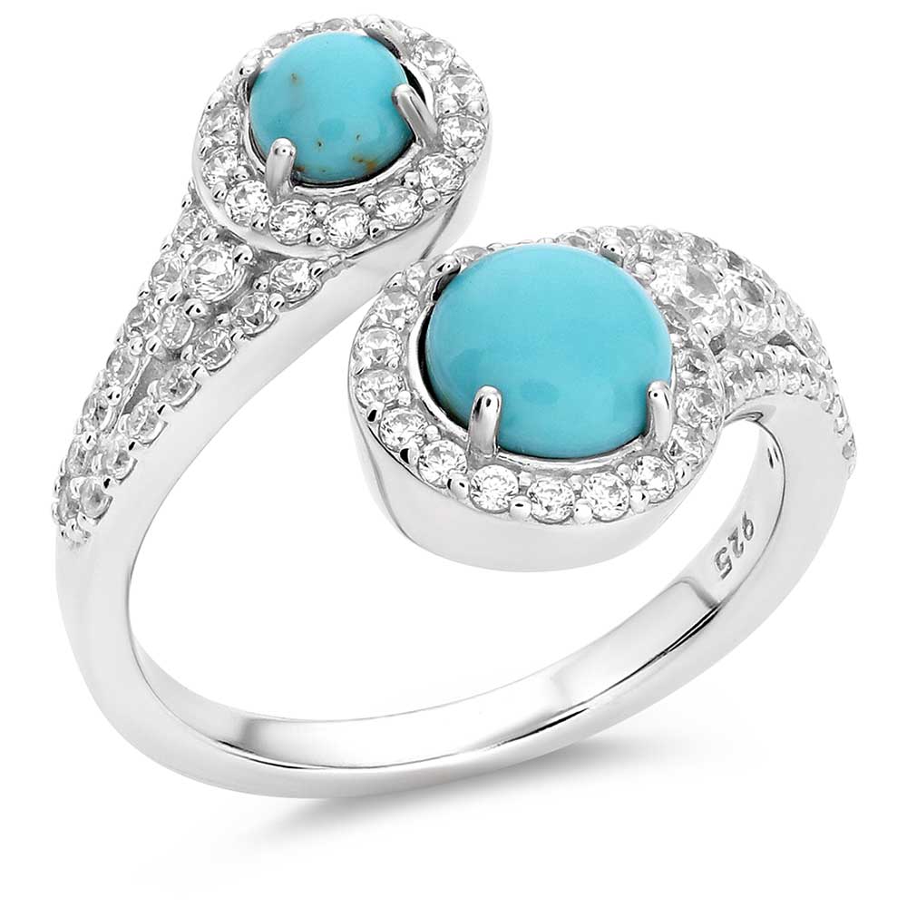 A sterling silver ring featuring two turquoise stones with a halo of smaller clear stones set 