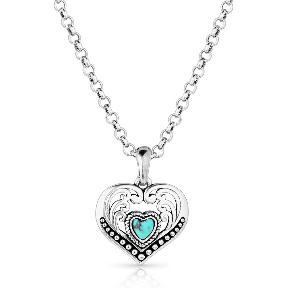 Silver necklace with a heart-shaped pendant featuring a turquoise stone on a white background
