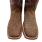 Pair of brown cowboy boots with intricate designs on a white background