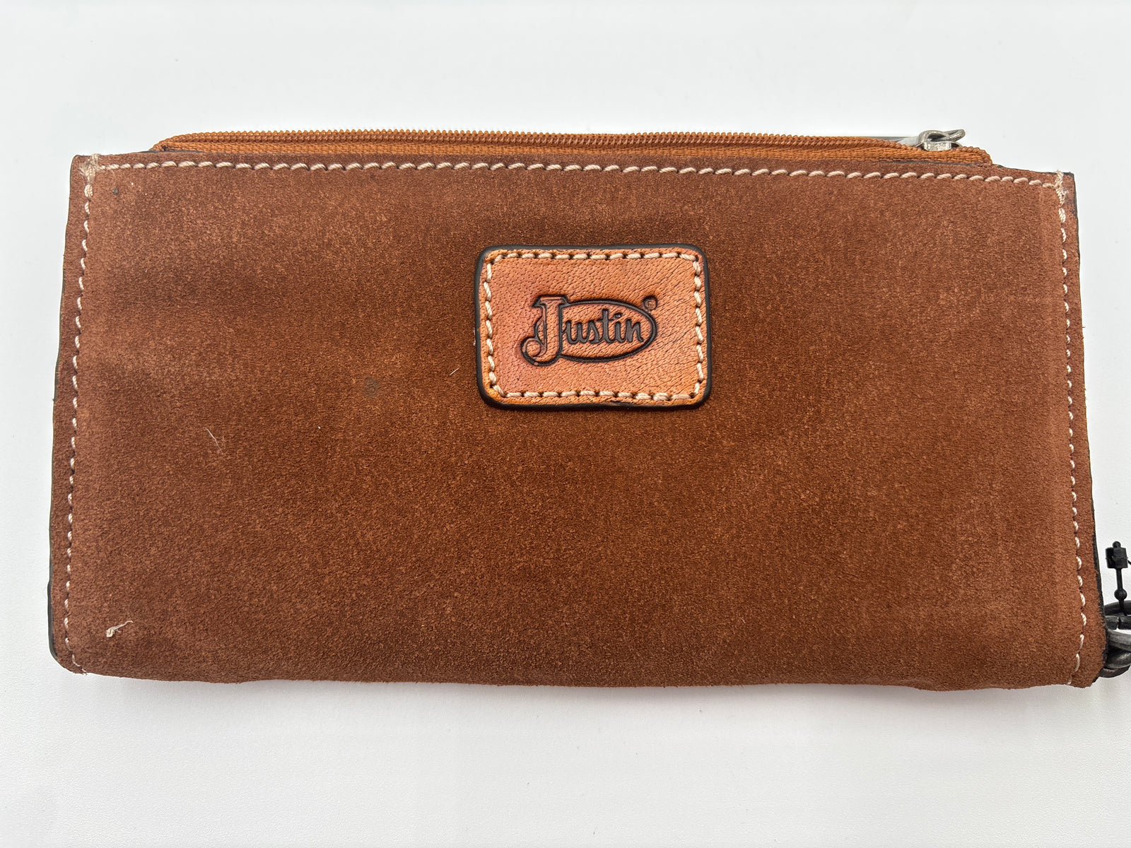 Brown leather wallet with 'Justin' brand logo 