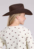 Woman wearing a brown cowboy hat and patterned shirt against a gray background