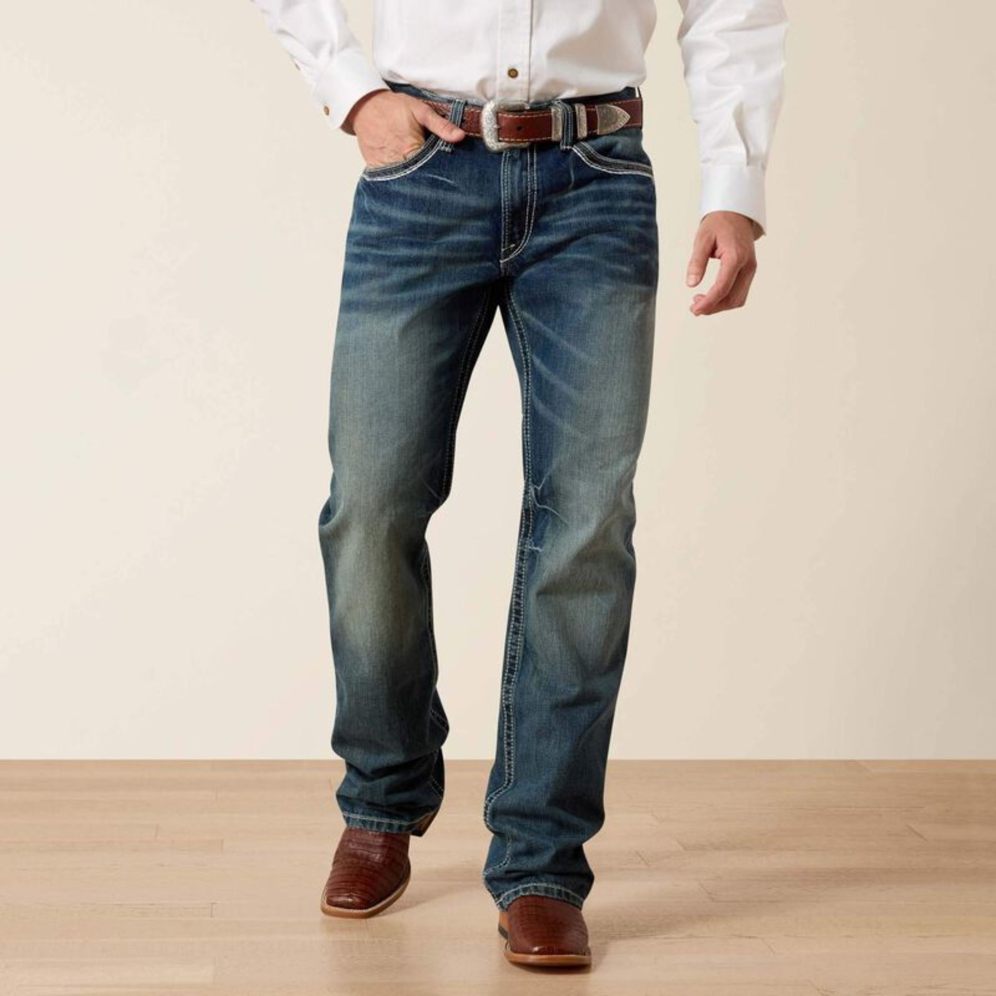 Person wearing Coltane pants and a white shirt with a brown belt