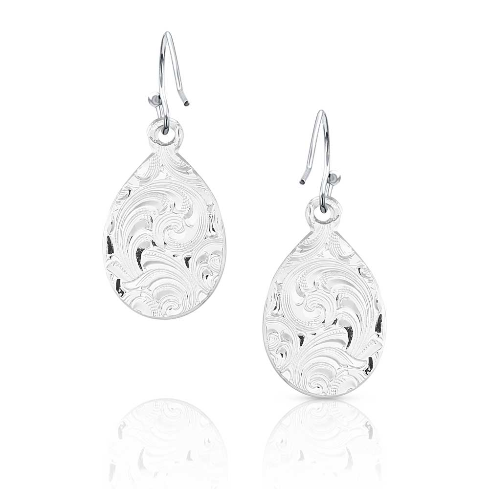 Silver teardrop earrings with intricate patterns on a white background