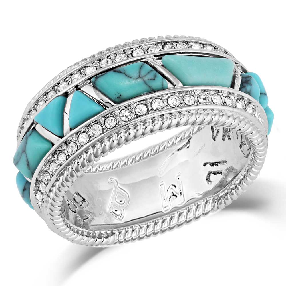 Turquoise ring with silver accents on a white background