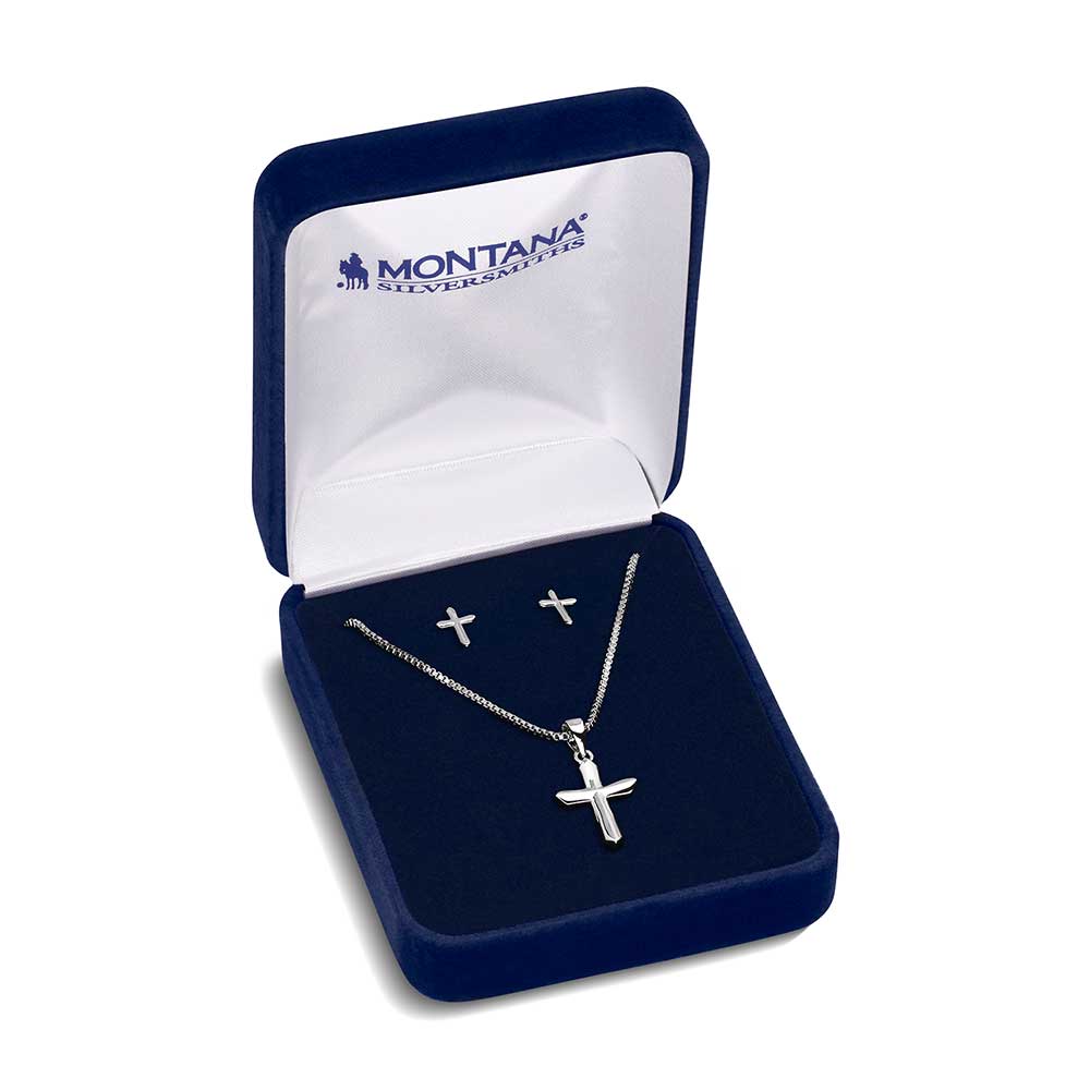 Silver cross necklace and earrings in a Montana Silversmiths box on a white background