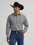 Man wearing a black cowboy hat, plaid shirt, and blue jeans on a gray background
