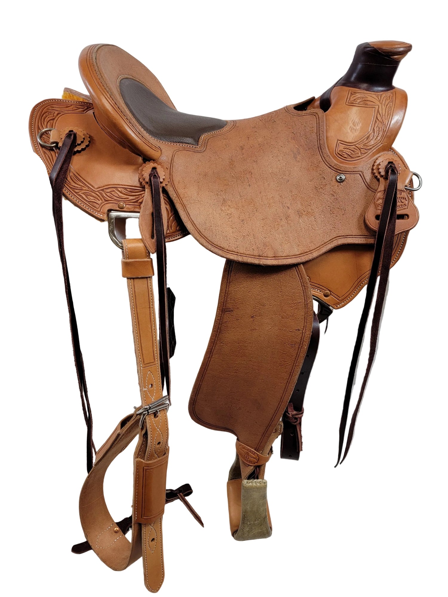 A classic leather western saddle with matching leather straps, stirrups, 