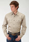 Man wearing a beige long-sleeve shirt with a belt on a white background