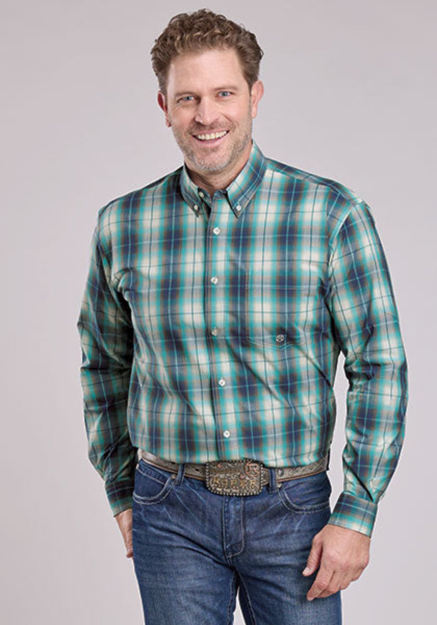 Man wearing a blue plaid shirt and jeans 