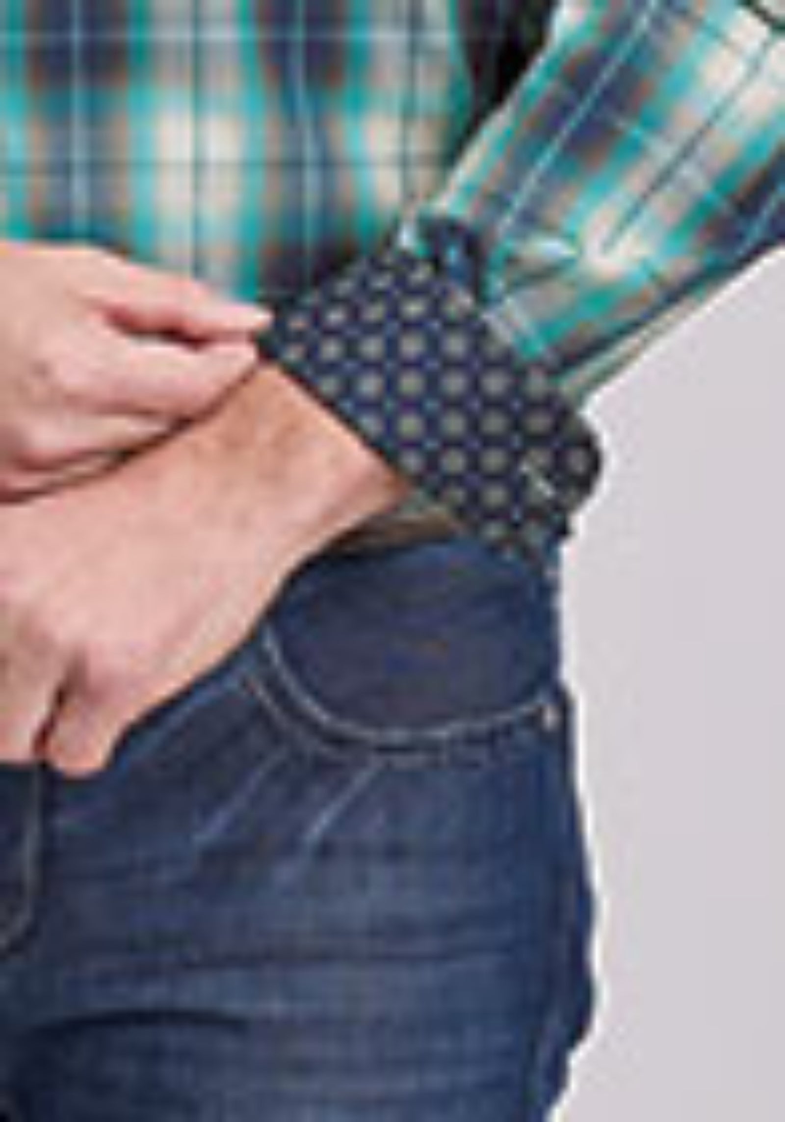Person wearing a plaid shirt and jeans