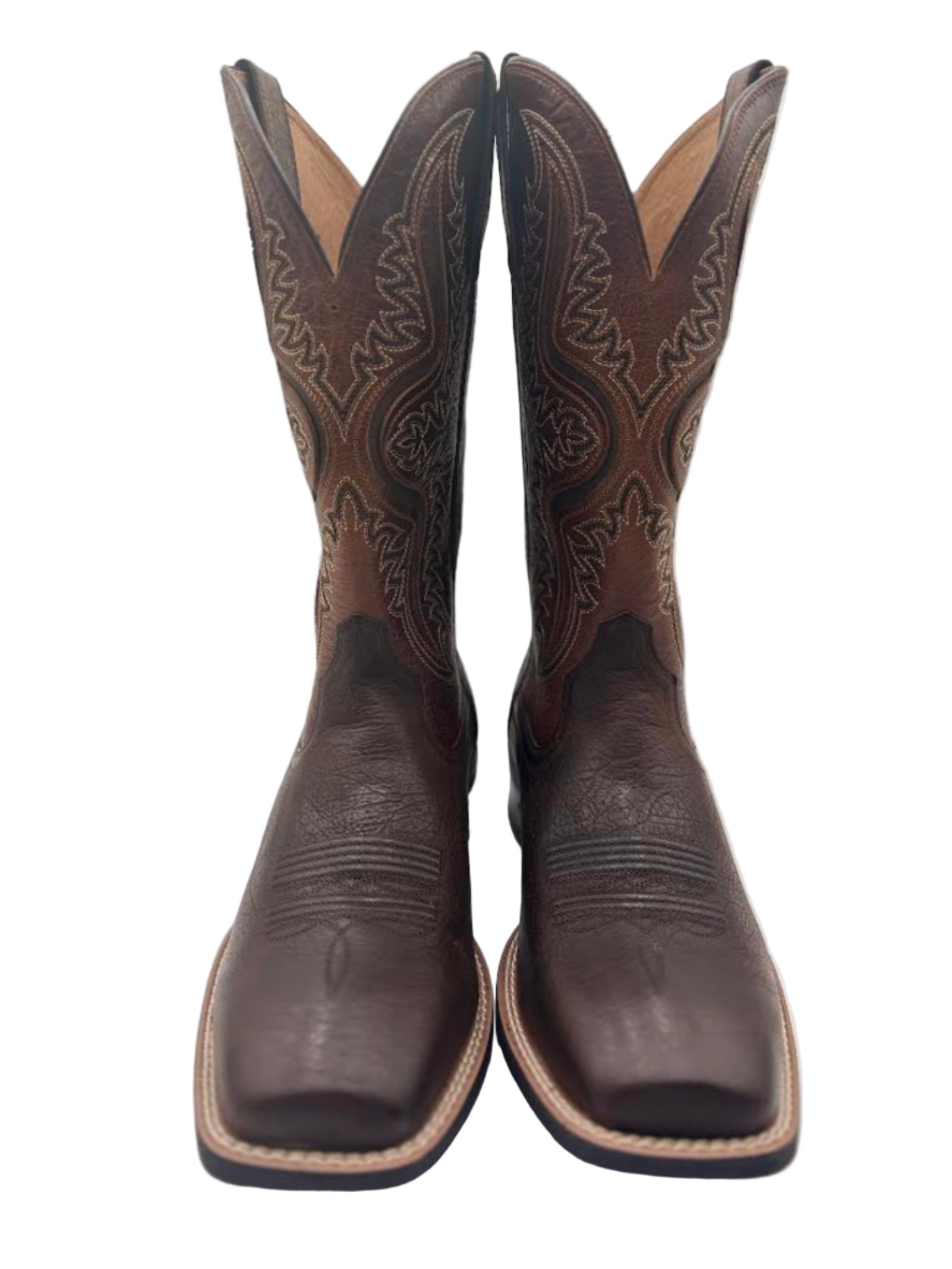 Pair of brown cowboy boots with intricate designs 