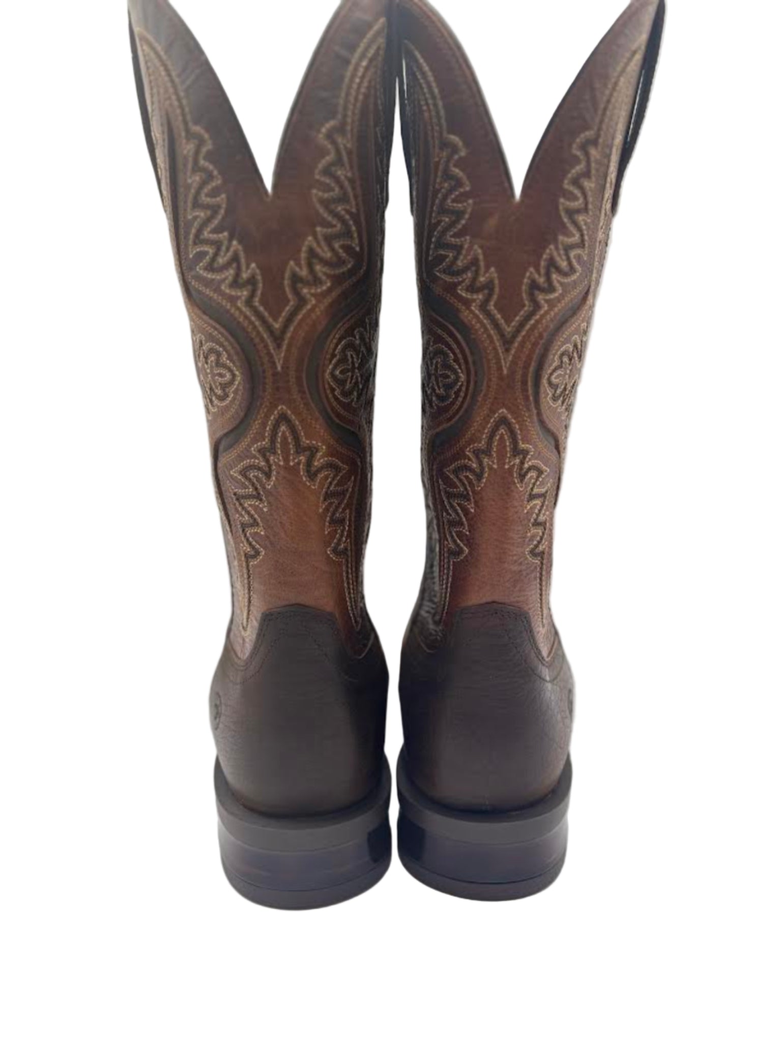 Pair of brown cowboy boots with stitching 