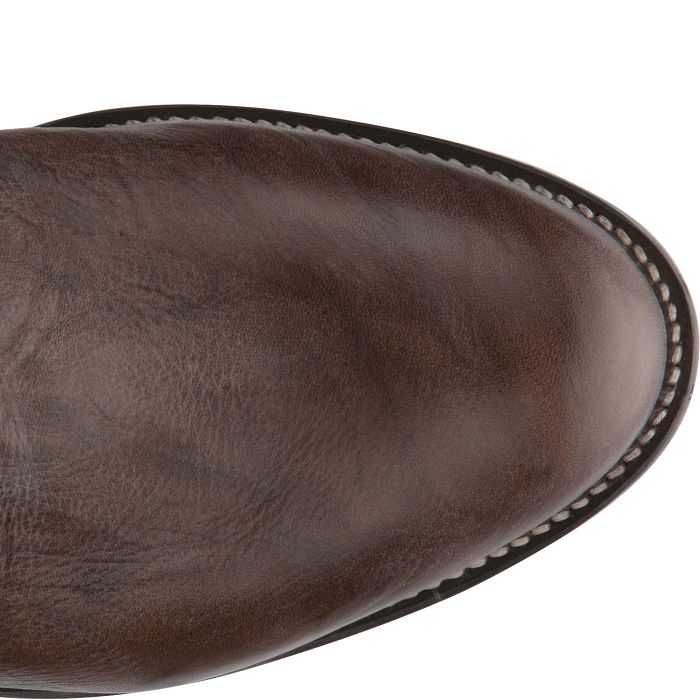 Close-up of a brown leather boot sole on a white background