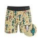Boxer briefs with a colorful desert-themed pattern on a beige background