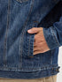 Close-up of a person wearing a blue denim jacket