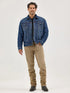 Man wearing a blue denim jacket and beige pants 