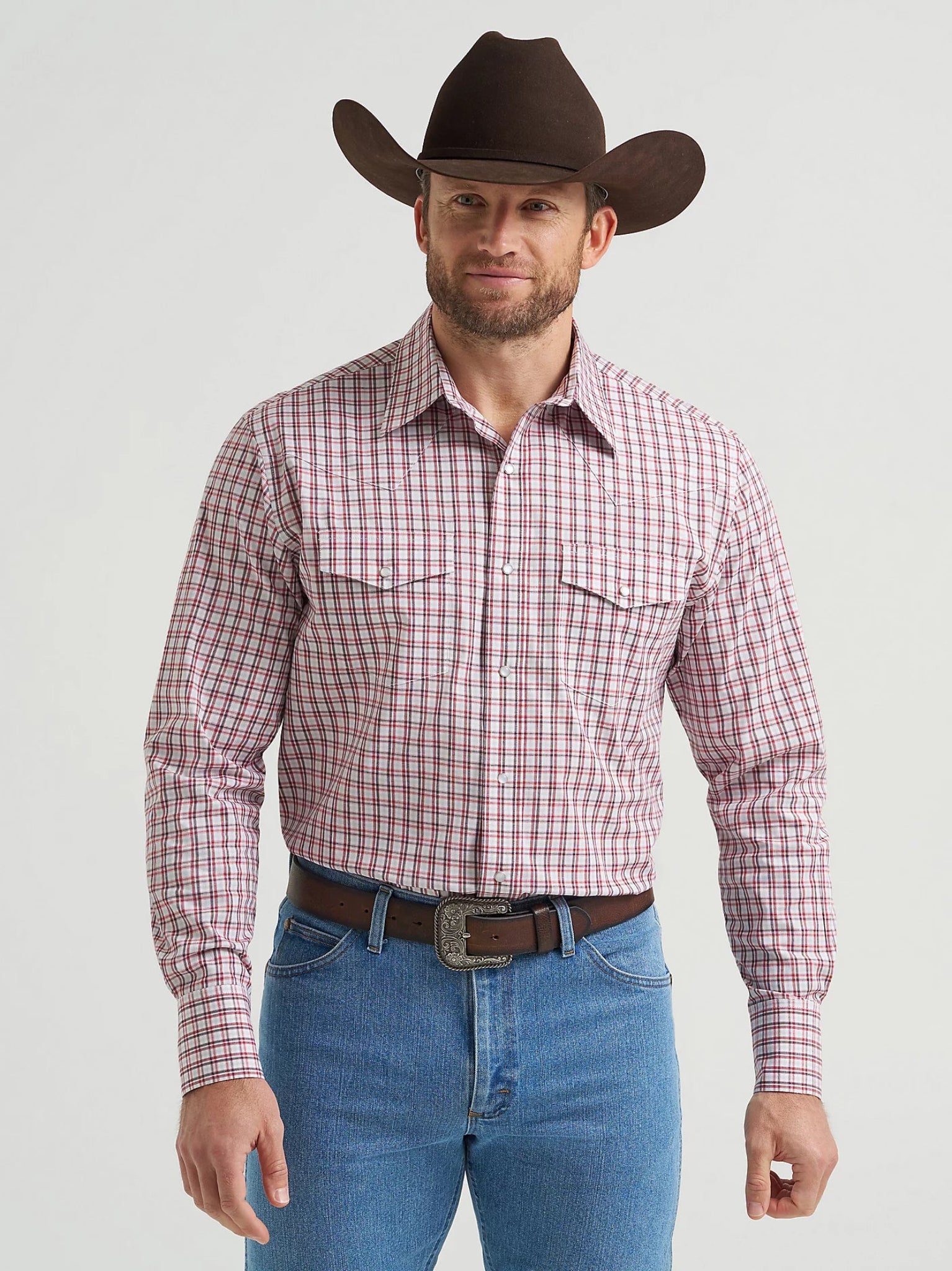 Man wearing a red plaid shirt, blue jeans