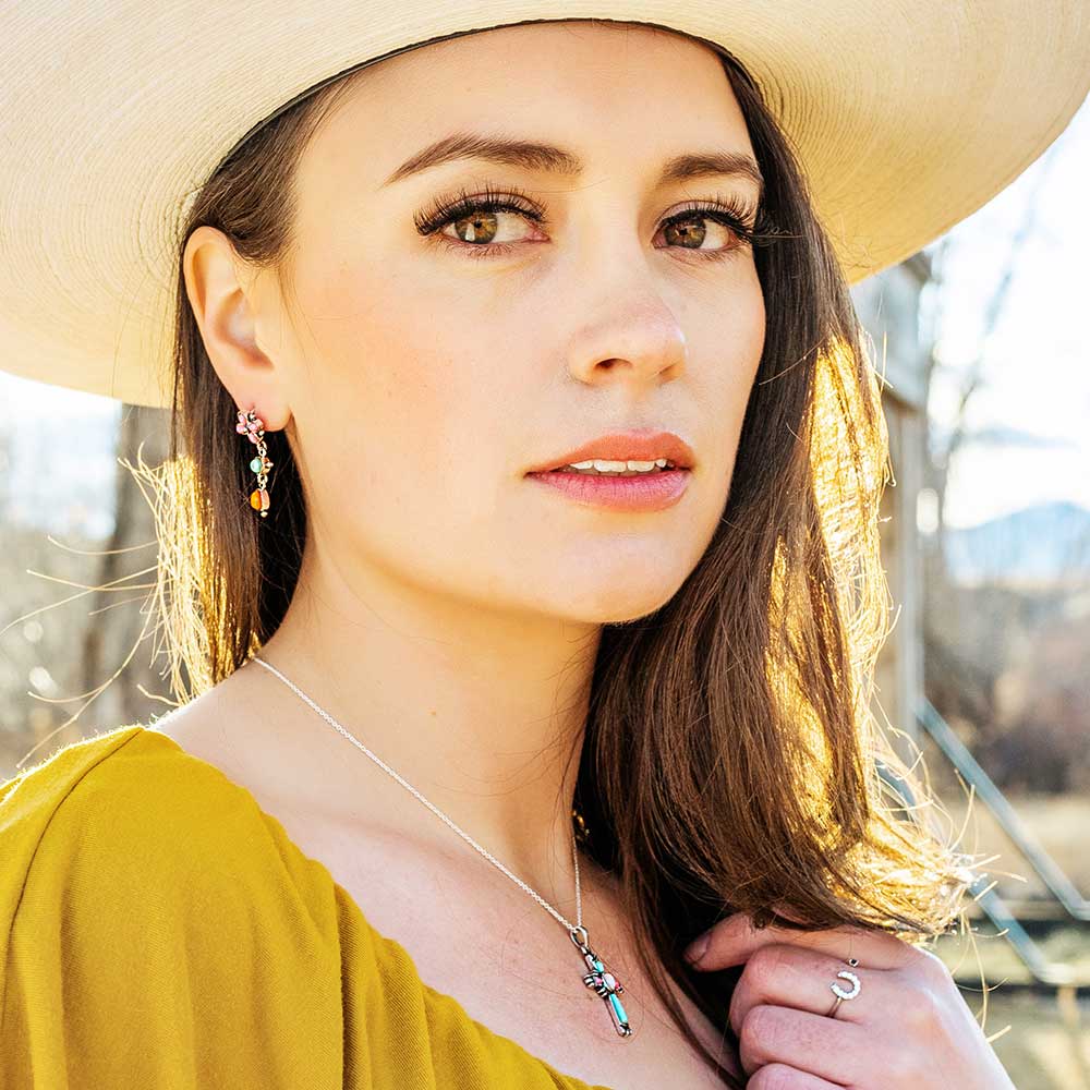 Woman wearing necklace and dress with a scenic background