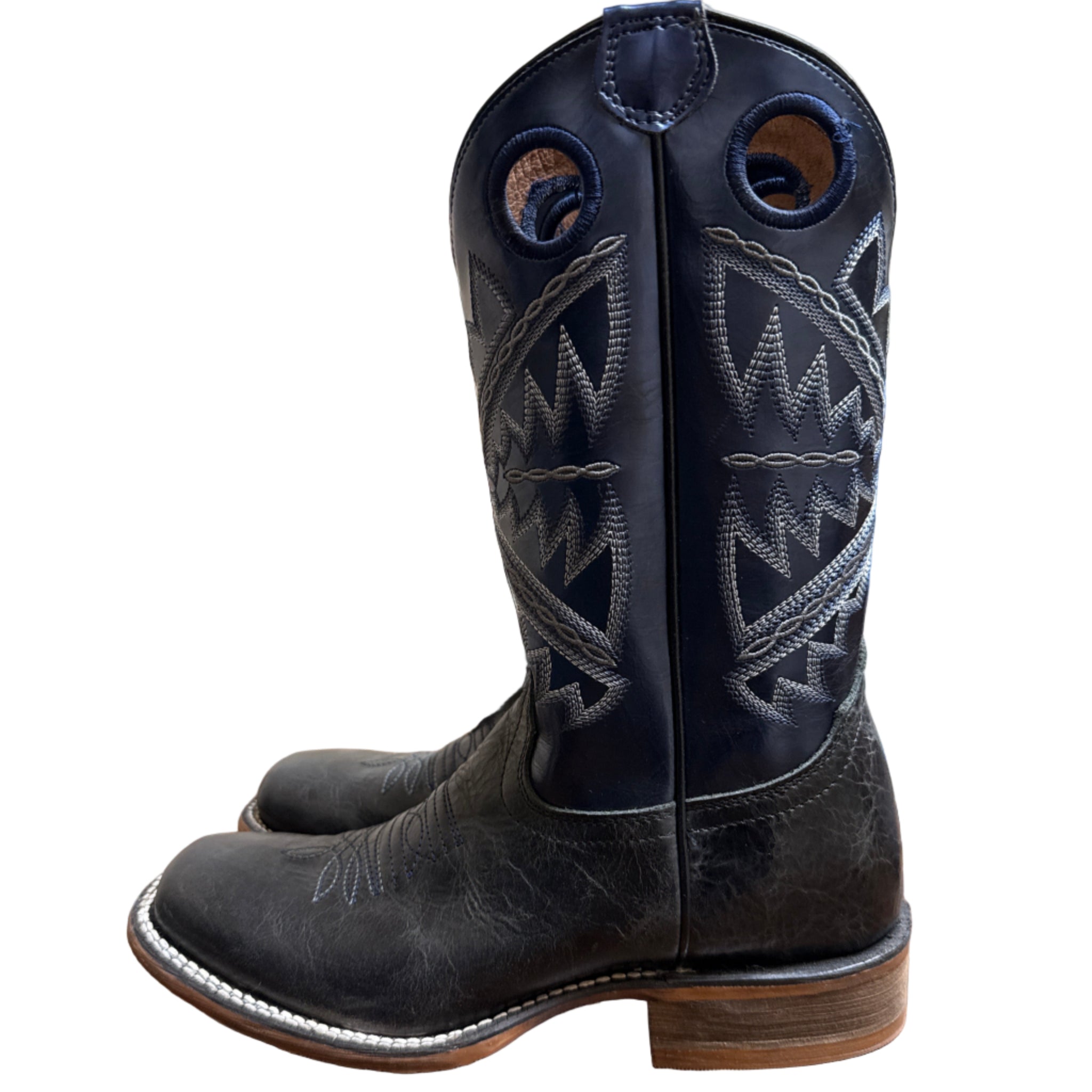 Black cowboy boot with intricate white stitching