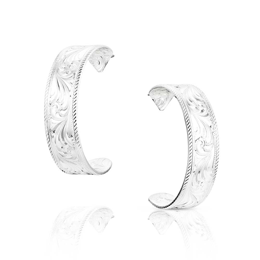 Pair of silver hoop earrings with intricate designs 