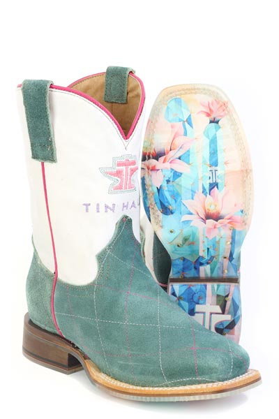A pair of children's boots with blue diamond patterns on the upper, turquoise suede and a brown sole with a cactus rose design.