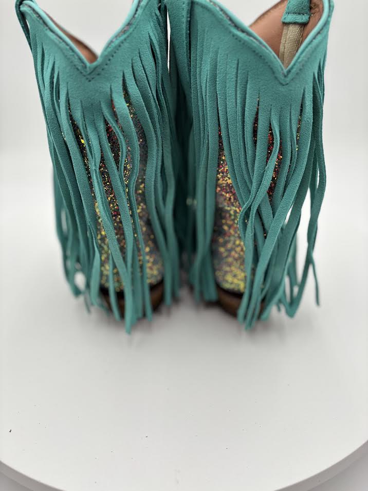 Teal suede fringe boots on a white background