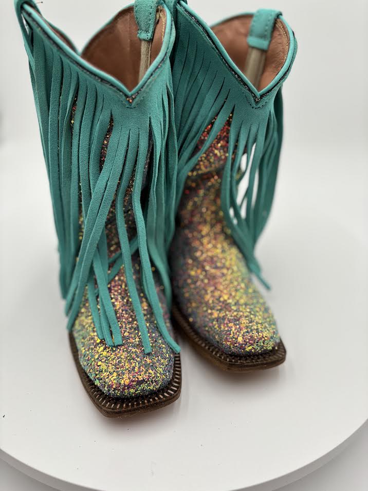 Turquoise fringed boots with glittery soles on a white background