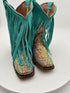 Turquoise fringed boots with glittery soles on a white background
