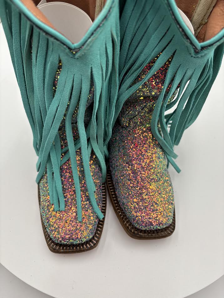 Turquoise fringed boots with multicolored glittery soles on a white background
