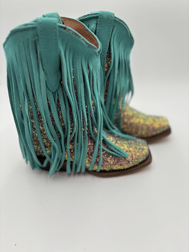 Turquoise fringe boots on a white background