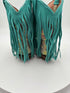 Teal suede fringe boots on a white background