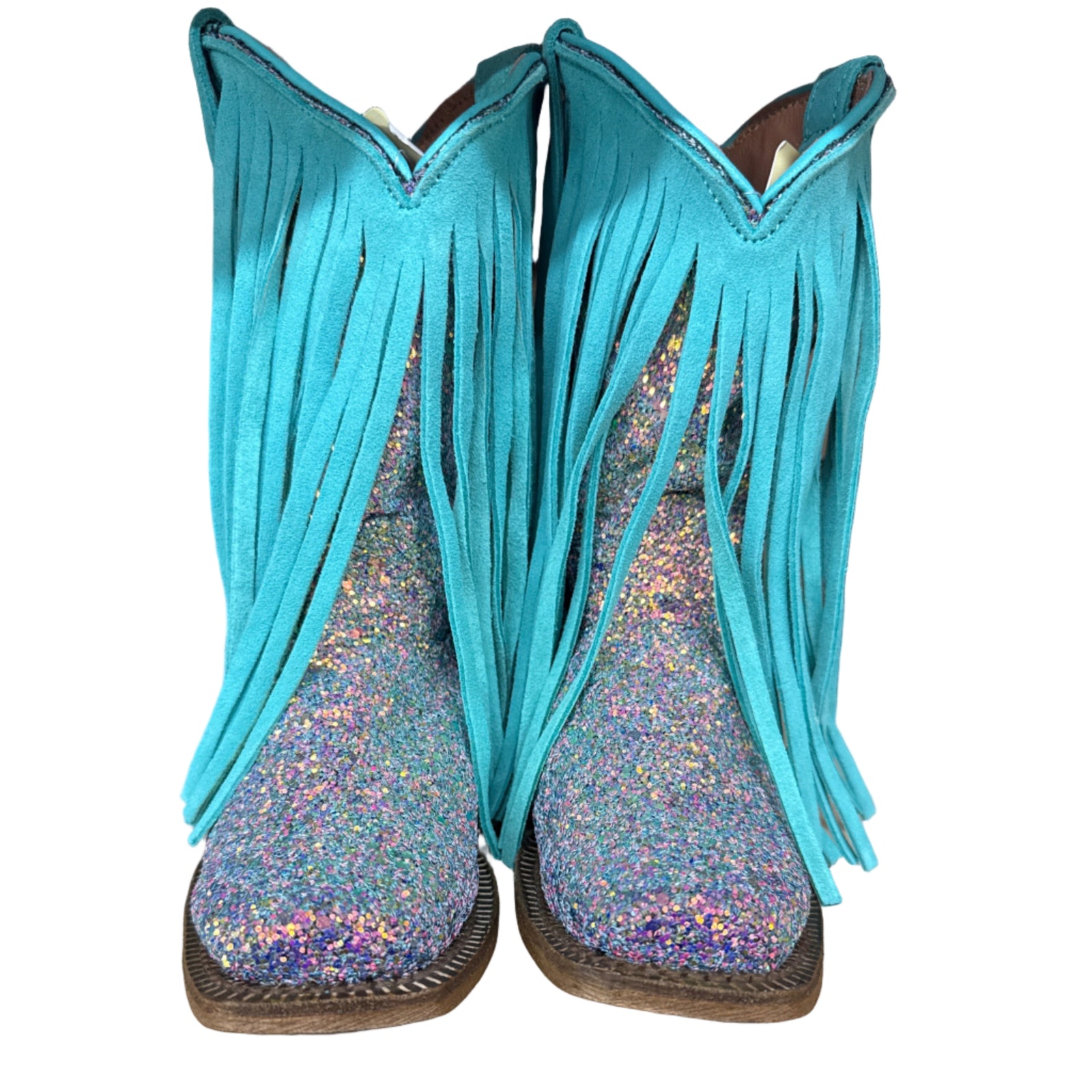 Turquoise fringe boot with glittery sole on a wooden shelf with other boots.