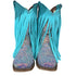 Turquoise fringe boot with glittery sole on a wooden shelf with other boots.
