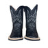 Pair of Infant black cowboy boots with intricate designs on a wooden surface and zipper sides.