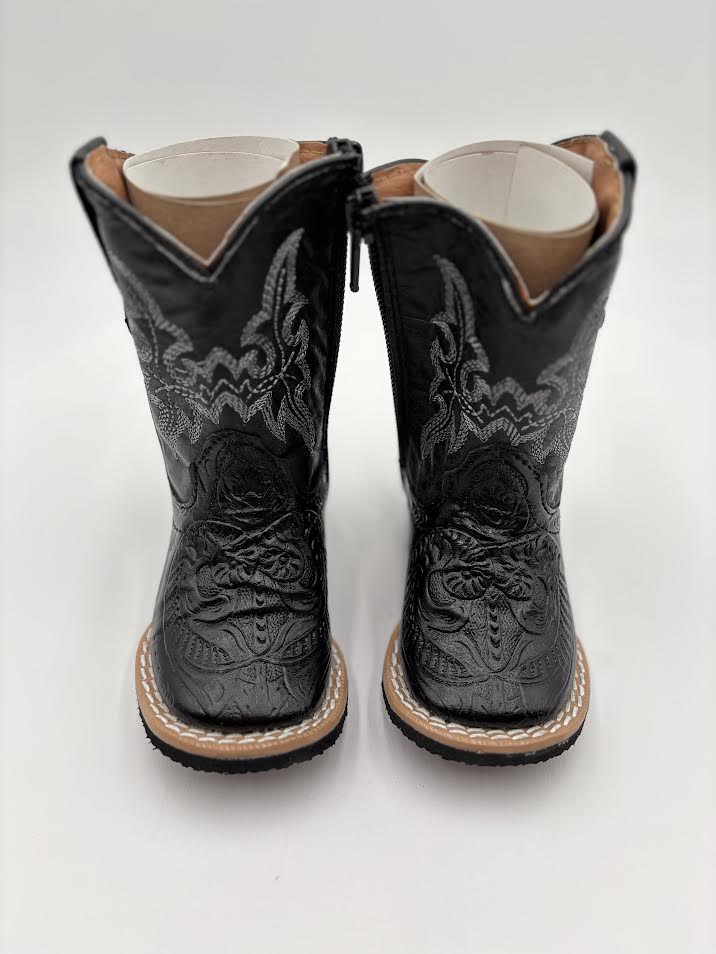 Pair of black cowboy boots with intricate designs on a white background